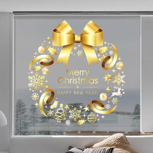 Detail of golden Christmas wreath window sticker with Merry Christmas greeting and bow