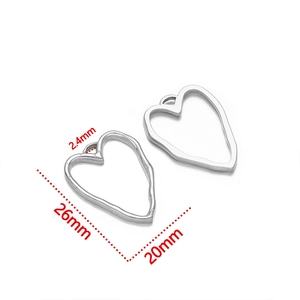 Macro shot of silver stainless steel heart pendant with dimensions 26mm by 20mm