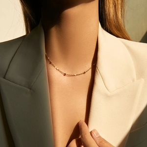 Minimalist gold-plated beaded chain necklace on model for professional business style