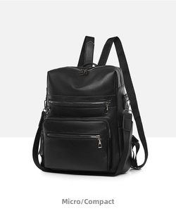 Detailed side view of black faux leather backpack with multiple zipper pockets