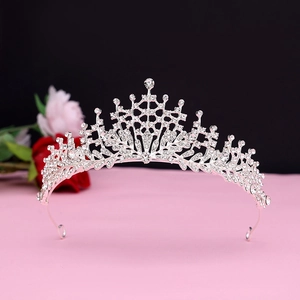 Detail of silver bridal tiara with sparkling crystal rhinestones and pointed spire design
