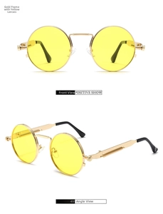 Detail of round steampunk sunglasses with gold metal frame and yellow tinted lenses