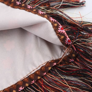 Ethnic vacation style skirt with multi-color tassels and textured brown fabric detail
