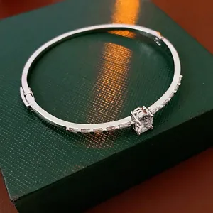 Silver oval hinged bracelet with large round zircon and side baguette diamonds