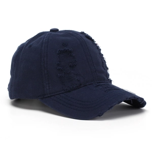 Close-up of distressed denim baseball cap showing vintage torn details and fabric texture