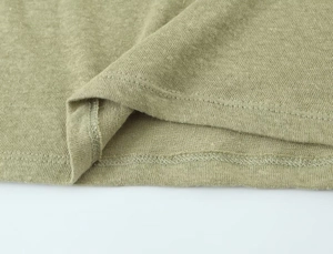 Macro shot of army green linen blend T-shirt hem showing stitching and knit texture
