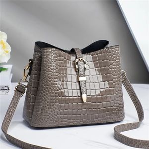 Elegant taupe crocodile pattern tote bag in glossy finish with gold buckle detail