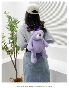 Close-up of soft purple teddy bear plush backpack worn by a model in a minimalist room