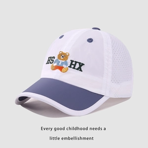 Detail of white mesh fabric on kids baseball cap with navy blue bear embroidery