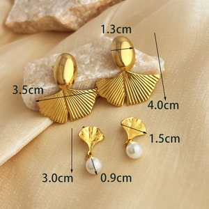 Elegant gold ginkgo leaf stud earrings with white pearl accents and size dimensions