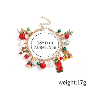 Detail view of a gold Christmas charm bracelet with measurement specs and holiday pendants