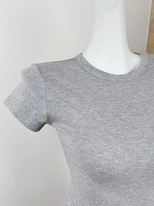 Close-up of gray ribbed knit texture and round neckline detail on a slim-fit sports T-shirt