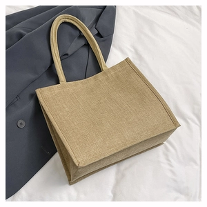 Detailed view of linen tote bag texture with reinforced stitching on white fabric