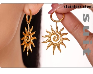 Detail of gold spiral sunburst drop earrings made of high-quality stainless steel