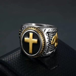 Close-up of hip-hop men's ring featuring golden cross inlay and retro engraved details