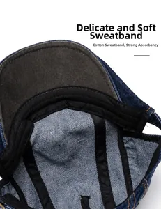 Close-up of soft black cotton sweatband and white stitching inside denim newsboy cap