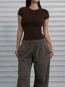 Slim fit dark brown short sleeve T-shirt paired with olive drawstring sports pants