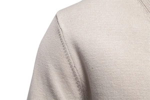 Macro shot of precise shoulder seam stitching on this beige fine knit cardigan sweater