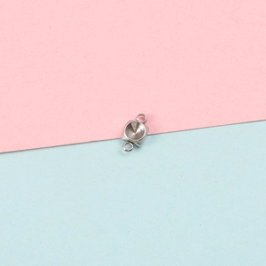 Close-up of polished stainless steel square charm base with circular bezel for DIY jewelry
