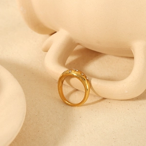 Gold plated stainless steel star moon ring with cubic zirconia on a ceramic cup handle