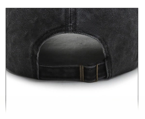 Detail of vintage washed black cotton baseball cap with adjustable copper metal buckle
