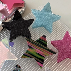 Macro shot of colorful glitter star hair claws in resin material for ponytail hair styling