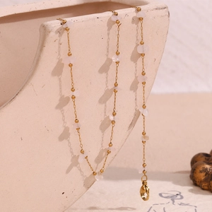 Detail of 18K gold plated necklace with delicate pink quartz stones and lobster clasp