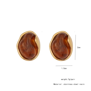 Detail view of oval amber resin earrings with stainless steel gold base and 2cm size mark