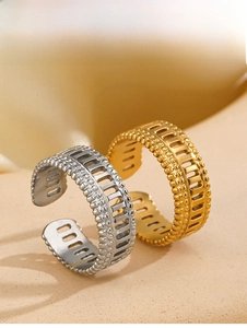 Macro detail of gold and silver Roman style open rings with hollow rectangle patterns
