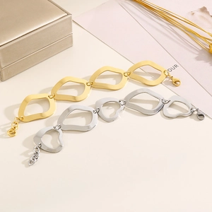 Irregular wavy geometric link bracelets in gold and silver steel on a jewelry box