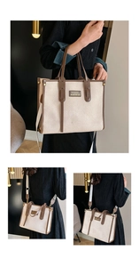 Detail of canvas tote bag with brown leather trim and detachable shoulder strap