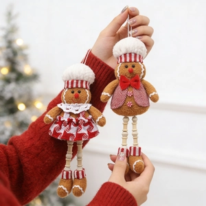 Detail of gingerbread man and woman plush ornaments with wooden bead legs on a Christmas tree