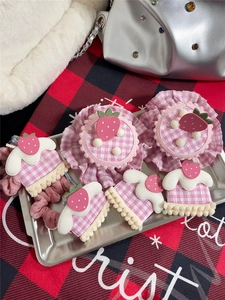 Pink strawberry hair accessories set with plaid patterns on a decorative silver tray