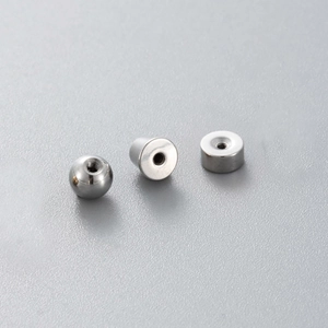 Polished stainless steel geometric ear piercing screw back replacements on gray background