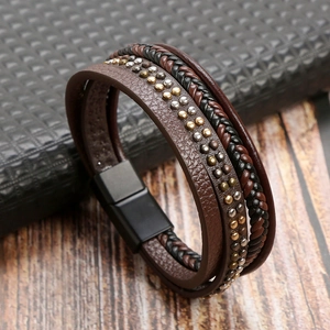 Detail of multi-layer braided leather bracelet with silver rivets and magnetic clasp