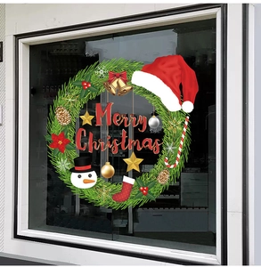 Detail of Christmas window stickers featuring green wreath, snowman, and Merry Christmas text
