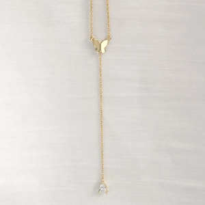 Detail of S925 silver butterfly necklace featuring a gold tassel and teardrop zircon pendant