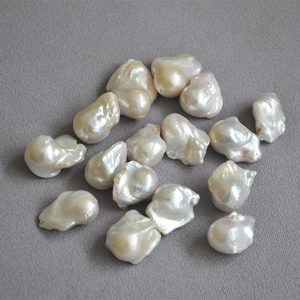 Macro detail of natural Baroque pearls showing creamy white luster and organic textures