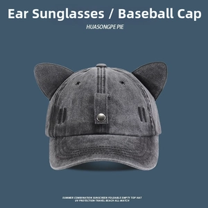 Detail of dark grey washed denim baseball cap with cat ear design and metal buckles