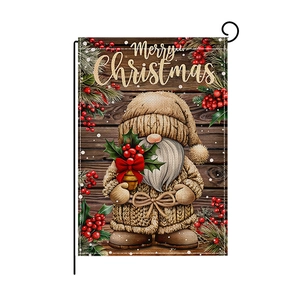 Christmas garden flag with gnome and Merry Christmas text on a black metal stand
