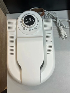 Detail view of foldable shoe dryer with LCD display showing 48 degrees and timer buttons