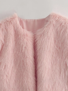 Gros plan du col de veste en fausse fourrure rose montrant la texture douce et la doublure