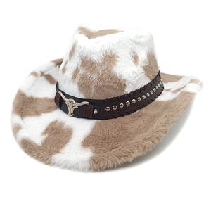 Detail of cow print cowboy hat with brown leather band and metal bull head ornament