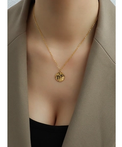 Detail of 18K gold-plated stainless steel necklace with round Fu character pendant
