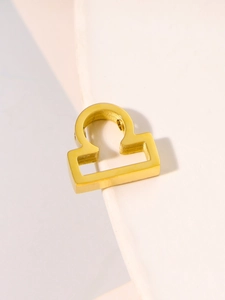 Close-up of golden stainless steel Libra zodiac charm for DIY jewelry making