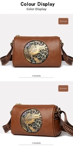 Detail of a brown Boston bag featuring ethnic elephant metal relief and textured leather
