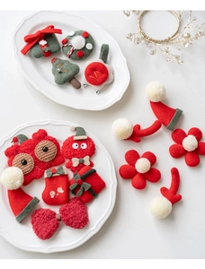 Detailed overhead shot of assorted felt Christmas hair accessories and ornaments