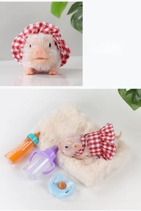 Detailed view of flocked silicone baby pig toy with red checkered outfit and nursing kit