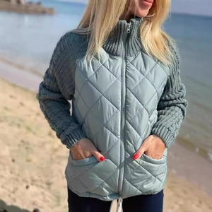 Detail view of quilted stitch texture and thick knitted sleeves on high collar jacket