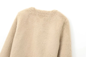 Close-up detail of soft faux fur texture on the back collar of a khaki crop coat
